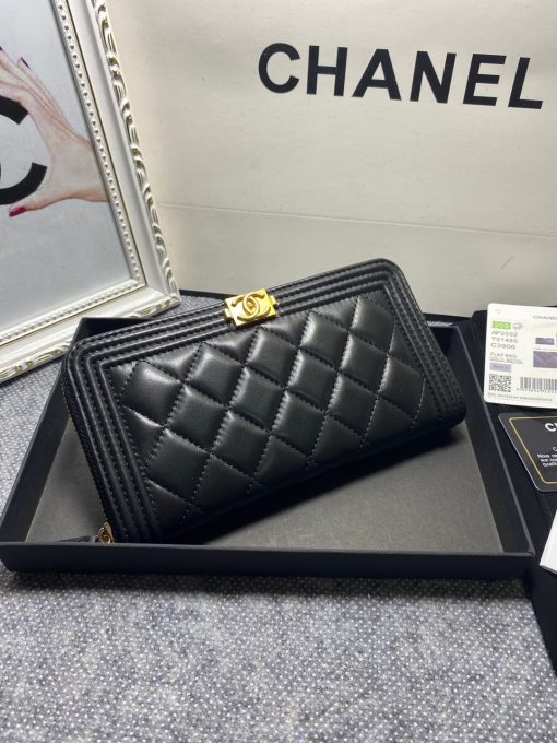 CHANEL 'Boy' Long Zipped Wallet. Original Quality Wallet with literature, dust bag, box and authenticity card. The Chanel 'Boy' Wallets have always been as popular as the Boy Chanel Quilted Bags. Everything about the design resemble to the Boy Bag line including the quilting with stripes on the edges and the boy clasp as well. The calfskin/lambskin makes sure that you don’t need to constantly babying it and it will not get damaged so easily if it sits next to your keys, inside your bag. This wallet is practical and amazing; perfect to hold paper money, credit cards and coins.