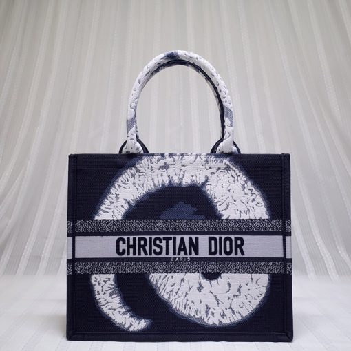 DIOR Book Tote. Original Quality Bag including gift box, care book, dust bag, authenticity card. This Book Tote is an original style introduced by Creative Director Maria Grazia Chiuri. This has become a staple of the Dior aesthetic. Ideally designed to carry all your daily essentials, the small shape is fully embroidered and the 'Christian Dior' signature on the front. This carryall is a perfect example of the Dior savoir-faire and also may be coordinated with a pouch or other small leather goods for a complete look.