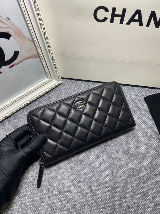 CHANEL Classic Long Zipped Wallet.  Original Quality Wallet including gift box, care book, dust bag, authenticity card. This wallet is one of the signature wallets of Chanel. It has been around for some time now and it will continue to stick around. This wallet is practical and amazing; perfect to hold paper money, credit cards and coins. The classic black color, you will get the signature burgundy colored interior. 