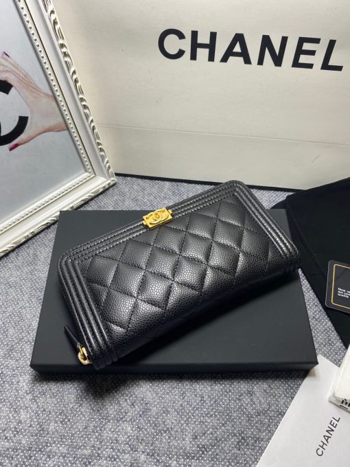 CHANEL 'Boy' Long Zipped Wallet. Original Quality Wallet with literature, dust bag, box and authenticity card. The Chanel 'Boy' Wallets have always been as popular as the Boy Chanel Quilted Bags. Everything about the design resemble to the Boy Bag line including the quilting with stripes on the edges and the boy clasp as well. The calfskin/lambskin makes sure that you don’t need to constantly babying it and it will not get damaged so easily if it sits next to your keys, inside your bag. This wallet is practical and amazing; perfect to hold paper money, credit cards and coins.