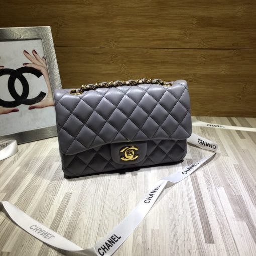 CHANEL Classic New Mini 20 cm Flap Bag. Original Quality Bag including gift box, care book, dust bag, authenticity card. This chic petite shoulder bag is crafted of luxurious shimmery lambskin leather. The crossbody bag features a long chain-link leather threaded shoulder strap and front flap with a CC turn lock. The flap opens to an interior of matching leather with zipper and patch pockets. Enjoy this fabulous bag for everyday essentials or special events with this timeless classic.