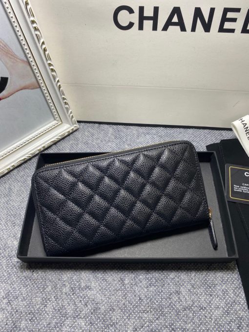 CHANEL Classic Long Zipped Wallet.  Original Quality Wallet including gift box, care book, dust bag, authenticity card. This wallet is one of the signature wallets of Chanel. It has been around for some time now and it will continue to stick around. This wallet is practical and amazing; perfect to hold paper money, credit cards and coins. The classic black color, you will get the signature burgundy colored interior. 