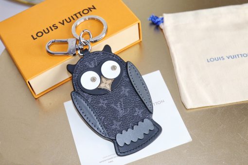 LOUIS VUITTON Owl Bag-Charm & Key Holder. Original Quality Charm including gift box, care book, dust bag, authenticity card. The mascot on the Owl bag charm and key holder is brought to life with LV studs for eyes and a Monogram Flower beak. Gold-color hardware joins calf leather and Monogram Eclipse canvas in a playful mingling of the House's signature materials. The hook and ring on this are both engraved with the Louis Vuitton signature for an elegant finish.