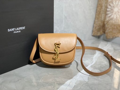 SAINT LAURENT Kaia YSL-Plaque Leather Cross-Body Bag. Original Quality Bag including gift box, care book, dust bag, authenticity card. SAINT LAURENT'S Kaia bag features the label's signature YSL plaque which was sketched by the graphic designer A.M. Cassandre, one of the 20th century's most prominent poster artists. It's crafted from leather to a curved silhouette that's reminiscent of a saddle, then accented by white topstitching. Carry it by the adjustable shoulder strap for contemporary polish.