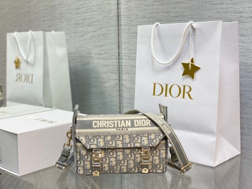 DIOR Small DiorCamp Bag. Original Quality Bag including gift box, care book, dust bag, authenticity card. Maria Grazia Chiuri has updated the classic messenger bag by adding signature Dior details for a relaxed and modern look. Fully embroidered with the Dior Oblique motif, the bag is enhanced by a 'CHRISTIAN DIOR PARIS' signature flap, as well as sportswear-inspired 'CD' buckles. Equipped with an adjustable and removable shoulder strap, the small, compact messenger bag can be worn over the shoulder or crossbody, and will make an ideal urban companion.