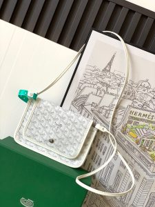GOYARD Plumet Pocket Wallet: Where Parisian Elegance Meets Functional Versatility. The Plumet pocket wallet derives its inspiration from the exquisite pocket featured in the Saint Louis bag. Paying a heartfelt tribute to the industrious laborers of Paris's vibrant ports, who skillfully navigated rafts to their destinations along the picturesque banks of the River Seine, this wallet seamlessly blends form and function. Crafted with dedicated compartments for coins, bills, and cards, the Plumet pocket wallet boasts a versatile design. It can be effortlessly worn across the chest, transforming into a chic miniature bag with the convenience of its removable strap. With its three distinct pockets, it gracefully accommodates its contents, adapting with elegance to your everyday needs.