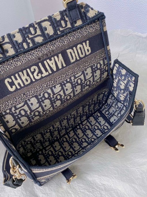 DIOR Small DiorCamp Bag. Original Quality Bag including gift box, care book, dust bag, authenticity card. Maria Grazia Chiuri has updated the classic messenger bag by adding signature Dior details for a relaxed and modern look. Fully embroidered with the Dior Oblique motif, the bag is enhanced by a 'CHRISTIAN DIOR PARIS' signature flap, as well as sportswear-inspired 'CD' buckles. Equipped with an adjustable and removable shoulder strap, the small, compact messenger bag can be worn over the shoulder or crossbody, and will make an ideal urban companion.