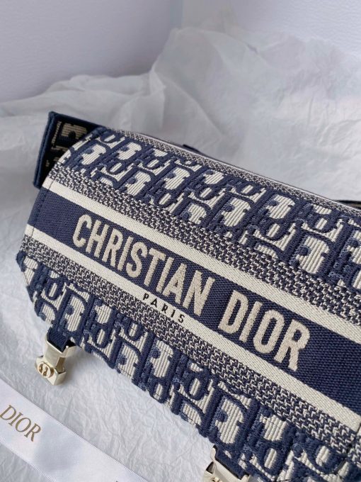 DIOR Small DiorCamp Bag. Original Quality Bag including gift box, care book, dust bag, authenticity card. Maria Grazia Chiuri has updated the classic messenger bag by adding signature Dior details for a relaxed and modern look. Fully embroidered with the Dior Oblique motif, the bag is enhanced by a 'CHRISTIAN DIOR PARIS' signature flap, as well as sportswear-inspired 'CD' buckles. Equipped with an adjustable and removable shoulder strap, the small, compact messenger bag can be worn over the shoulder or crossbody, and will make an ideal urban companion.