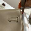HERMÈS Swift Kelly Moove: Classic Elegance, Modern Flair. Discover the reimagined elegance of the Kelly Moove, where timeless style meets modern innovation. Building on the iconic silhouette of the beloved Kelly Banana bag, the Kelly Moove adds a fresh twist with an irresistibly chic detachable mini pouch on its strap. This miniature version of the Kelly is more than just a pretty accessory—it’s a practical companion perfect for holding essentials like AirPods or credit cards. Together, this mother-and-daughter duo brings both style and function to the forefront, making the Kelly Moove a must-have for those who appreciate classic design with a contemporary flair. Elevate your look with this sophisticated piece that seamlessly blends tradition with today’s needs.