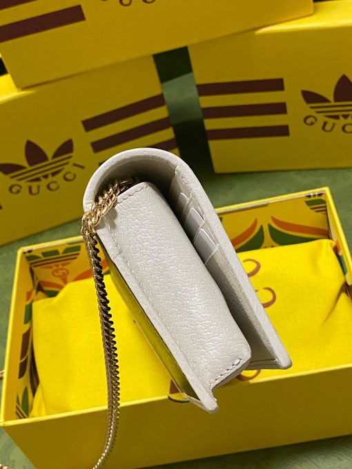 GUCCI X ADIDAS Wallet With Chain.  Original Quality Wallet including gift box, care book, dust bag, authenticity card. Part of the GUCCI X ADIDAS collection, this chain wallet features the Gucci Trefoil print. Emblematic House’s motifs mix with those of the historic sportswear brand adidas. The collection sees both heritages encoded in a trio of lines, where adidas and Gucci combine archival emblems. Creative Director, Alessandro Michele pulls inspiration from his memories of the ‘80s and ‘90s for a collection that is both nostalgia-driven and contemporary.