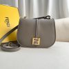 FENDI C’mon Medium. Timeless Elegance, Embodied in Leather. Elegantly designed, this medium-sized satchel bag boasts graceful, curved lines that exude femininity. Its elongated flap is adorned with a striking metal FF logo, adding a touch of sophistication to its overall charm. Crafted from supple leather with meticulously embossed edges and intricate details, this bag radiates a sense of refined luxury. The sides of the bag seamlessly blend with the overall design, crafted from the same tone-on-tone full-grain leather, ensuring a harmonious and visually pleasing aesthetic.