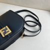 FENDI C’mon Medium. Timeless Elegance, Embodied in Leather. Elegantly designed, this medium-sized satchel bag boasts graceful, curved lines that exude femininity. Its elongated flap is adorned with a striking metal FF logo, adding a touch of sophistication to its overall charm. Crafted from supple leather with meticulously embossed edges and intricate details, this bag radiates a sense of refined luxury. The sides of the bag seamlessly blend with the overall design, crafted from the same tone-on-tone full-grain leather, ensuring a harmonious and visually pleasing aesthetic.