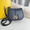 FENDI C’mon Medium. Timeless Elegance, Embodied in Leather. Elegantly designed, this medium-sized satchel bag boasts graceful, curved lines that exude femininity. Its elongated flap is adorned with a striking metal FF logo, adding a touch of sophistication to its overall charm. Crafted from supple leather with meticulously embossed edges and intricate details, this bag radiates a sense of refined luxury. The sides of the bag seamlessly blend with the overall design, crafted from the same tone-on-tone full-grain leather, ensuring a harmonious and visually pleasing aesthetic.