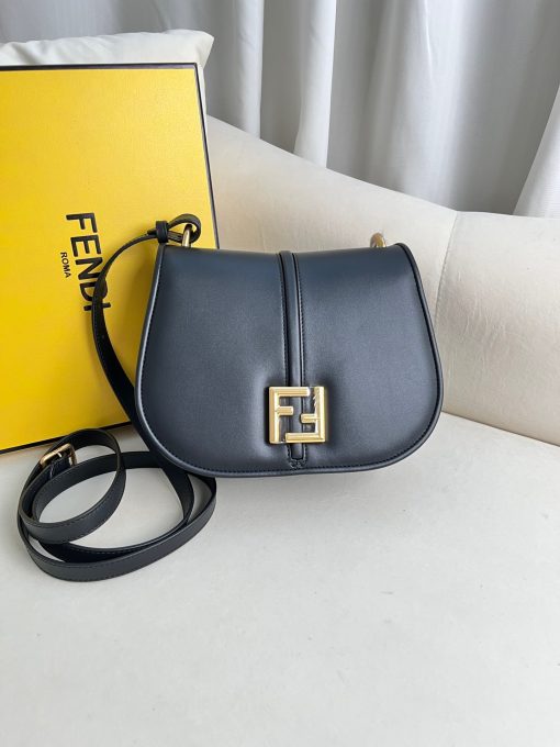 FENDI C’mon Medium. Timeless Elegance, Embodied in Leather. Elegantly designed, this medium-sized satchel bag boasts graceful, curved lines that exude femininity. Its elongated flap is adorned with a striking metal FF logo, adding a touch of sophistication to its overall charm. Crafted from supple leather with meticulously embossed edges and intricate details, this bag radiates a sense of refined luxury. The sides of the bag seamlessly blend with the overall design, crafted from the same tone-on-tone full-grain leather, ensuring a harmonious and visually pleasing aesthetic.