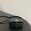 FENDI C’mon Mini. Embrace Elegance: Stefano Pilati's Curvaceous Creation. A petite satchel bag, graced with graceful, feminine curves, represents a masterpiece from the illustrious collection envisioned by the renowned Stefano Pilati. Fashioned from sumptuously smooth leather, this exquisite piece is adorned with meticulously embossed accents and edges, culminating in a striking FF logo proudly showcased on its elegant flap.