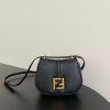 FENDI C’mon Mini. Embrace Elegance: Stefano Pilati's Curvaceous Creation. A petite satchel bag, graced with graceful, feminine curves, represents a masterpiece from the illustrious collection envisioned by the renowned Stefano Pilati. Fashioned from sumptuously smooth leather, this exquisite piece is adorned with meticulously embossed accents and edges, culminating in a striking FF logo proudly showcased on its elegant flap.