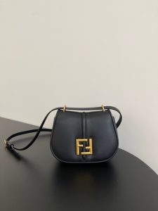 FENDI C’mon Mini. Embrace Elegance: Stefano Pilati's Curvaceous Creation. A petite satchel bag, graced with graceful, feminine curves, represents a masterpiece from the illustrious collection envisioned by the renowned Stefano Pilati. Fashioned from sumptuously smooth leather, this exquisite piece is adorned with meticulously embossed accents and edges, culminating in a striking FF logo proudly showcased on its elegant flap.