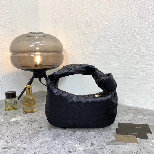 BOTTEGA VENETA The Jodie Hobo Bag. Original Quality Bag including gift box, care book, dust bag, authenticity card. This rounded mini hobo bag in woven leather is woven by hand with a curved, seamless structure. It has Iconic Intrecciato 15 weaves in a subtly amplified new dimension. This bag is soft, draped shape with knot detail on the handle.