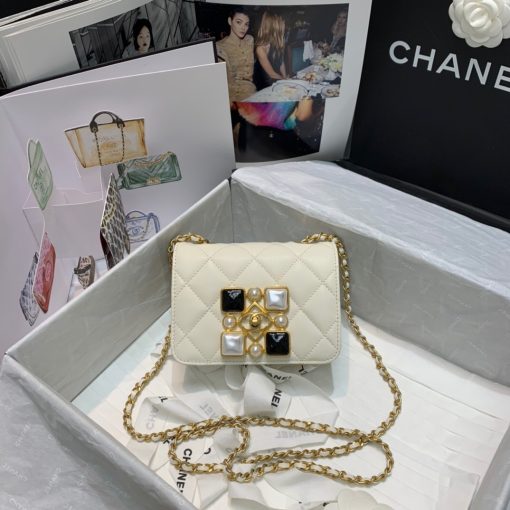 CHANEL Small Flap Bag with Crystal Pearls and Resin. Original Quality Bag including gift box, care book, dust bag, authenticity card. Chanel has introduced the Small Flap Bag in a bejeweled variant at Fall-Winter 2020/21 season. The bag is subtly blingy featuring faux pearls and Chanel’s Gripoix (poured glass jewels) on the clasp.