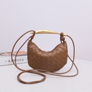 BOTTEGA VENETA Mini Sardine. Crafted to Perfection, Inspired by Nature: Your Timeless Companion for All Occasions. Bottega Veneta's masterful intrecciato weaving technique was originally crafted to ensure the enduring quality of leather goods. The Sardine Mini leather shoulder bag, meticulously fashioned from supple lamb leather, showcases a distinctive top handle reminiscent of a graceful fish. This versatile piece seamlessly transitions from day to night, making it the perfect, reliable companion to elegantly accommodate all your essentials.