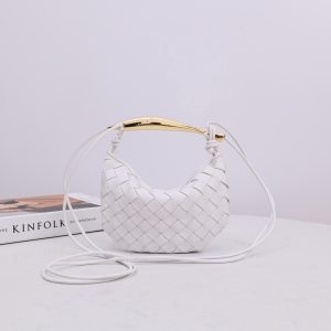BOTTEGA VENETA Mini Sardine. Crafted to Perfection, Inspired by Nature: Your Timeless Companion for All Occasions. Bottega Veneta's masterful intrecciato weaving technique was originally crafted to ensure the enduring quality of leather goods. The Sardine Mini leather shoulder bag, meticulously fashioned from supple lamb leather, showcases a distinctive top handle reminiscent of a graceful fish. This versatile piece seamlessly transitions from day to night, making it the perfect, reliable companion to elegantly accommodate all your essentials.