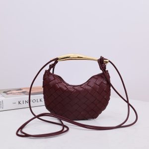 BOTTEGA VENETA Mini Sardine. Crafted to Perfection, Inspired by Nature: Your Timeless Companion for All Occasions. Bottega Veneta's masterful intrecciato weaving technique was originally crafted to ensure the enduring quality of leather goods. The Sardine Mini leather shoulder bag, meticulously fashioned from supple lamb leather, showcases a distinctive top handle reminiscent of a graceful fish. This versatile piece seamlessly transitions from day to night, making it the perfect, reliable companion to elegantly accommodate all your essentials.