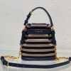 DIOR Small C'est Bag: Timeless Elegance, Effortless Style. Introducing the C'est Dior bag, a timeless and elegant creation for Fall 2023. Crafted in natural and denim blue raffia, it beautifully features the classic Marinière motif from ready-to-wear. Securing your essentials with a sophisticated CD Lock closure adorned with a twisting letter D, this bucket bag combines style with practicality. With a top handle and an adjustable, removable chain strap featuring a leather insert, this small-sized bag offers versatile carrying options—be it hand-held or comfortably draped over the shoulder.