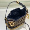 DIOR Small C'est Bag: Timeless Elegance, Effortless Style. Introducing the C'est Dior bag, a timeless and elegant creation for Fall 2023. Crafted in natural and denim blue raffia, it beautifully features the classic Marinière motif from ready-to-wear. Securing your essentials with a sophisticated CD Lock closure adorned with a twisting letter D, this bucket bag combines style with practicality. With a top handle and an adjustable, removable chain strap featuring a leather insert, this small-sized bag offers versatile carrying options—be it hand-held or comfortably draped over the shoulder.