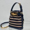 DIOR Small C'est Bag: Timeless Elegance, Effortless Style. Introducing the C'est Dior bag, a timeless and elegant creation for Fall 2023. Crafted in natural and denim blue raffia, it beautifully features the classic Marinière motif from ready-to-wear. Securing your essentials with a sophisticated CD Lock closure adorned with a twisting letter D, this bucket bag combines style with practicality. With a top handle and an adjustable, removable chain strap featuring a leather insert, this small-sized bag offers versatile carrying options—be it hand-held or comfortably draped over the shoulder.