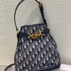 DIOR Small C'est Bag: Timeless Elegance, Effortless Style. Introducing the C'est Dior bag, a timeless and elegant creation for Fall 2023. Crafted in natural and denim blue raffia, it beautifully features the classic Marinière motif from ready-to-wear. Securing your essentials with a sophisticated CD Lock closure adorned with a twisting letter D, this bucket bag combines style with practicality. With a top handle and an adjustable, removable chain strap featuring a leather insert, this small-sized bag offers versatile carrying options—be it hand-held or comfortably draped over the shoulder.