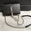 SAINT LAURENT Small 'Kate' Bag with Tassel. Original Quality Bag including gift box, care book, dust bag, authenticity card. Monogram Saint Laurent bag adorned with a curb chain, interlocking YSL initials in metal, and a metallic tassel. Crafted from leather, this Kate shoulder bag from Saint Laurent is decorated with a signature YSL monogram plaque and a hanging tassel detail to the front for an extra refined touch. The perfect go-to for a night out. Featuring a chain shoulder strap, a foldover top with magnetic closure, a main internal compartment, an internal slip pocket, an internal logo patch, an internal logo stamp, and metal hardware.