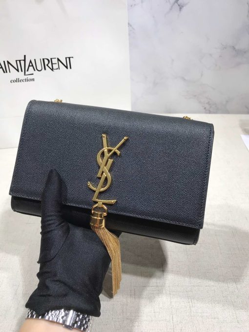 SAINT LAURENT Small 'Kate' Bag with Tassel. Original Quality Bag including gift box, care book, dust bag, authenticity card. Monogram Saint Laurent bag adorned with a curb chain, interlocking YSL initials in metal, and a metallic tassel. Crafted from leather, this Kate shoulder bag from Saint Laurent is decorated with a signature YSL monogram plaque and a hanging tassel detail to the front for an extra refined touch. The perfect go-to for a night out. Featuring a chain shoulder strap, a foldover top with magnetic closure, a main internal compartment, an internal slip pocket, an internal logo patch, an internal logo stamp, and metal hardware.