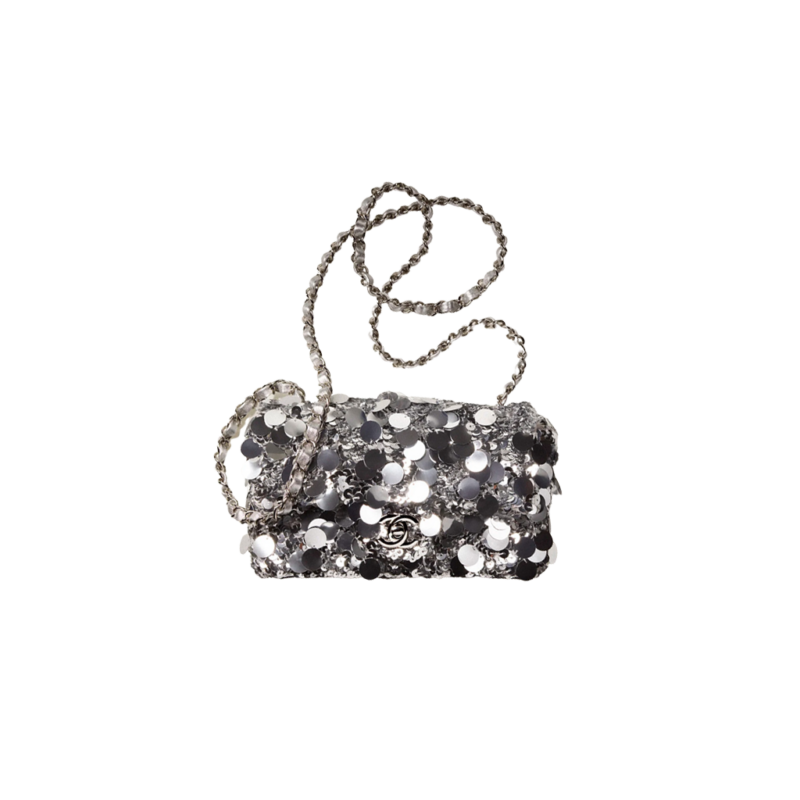 CHANEL Mini Flap Bag In Sequins. Original Quality Bag including gift box, care book, dust bag, authenticity card. This small sleek flap bag is beautifully crafted of the layering of small and large sequins that create the entire surface of the bag. The elegant handbag features polished chain link leather threaded shoulder straps and a Chanel CC turn lock. This opens to a leather interior with room for your necessities for day or evening with the timeless style.