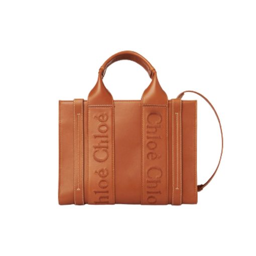 CHLOÉ Woody Tote Bag.  Original Quality Bag including gift box, care book, dust bag, authenticity card. Crafted from smooth calfskin for a natural look with a unique, luxurious feel, this Woody tote bag is a soft day-to-evening bag with a long, removable strap in addition to the top handles. The roomy inside compartment includes a practical flat pocket in leather for an elevated touch. Linen lining matches a refined finish with a lower environmental impact. The Woody line is characterised by the signature Chloé logo carried over from the Maison's iconic mules. It showcases a modern, minimalist silhouette.