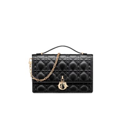 Miss Dior Top Handle Bag– Your Day to Evening Essential. Elegance in Every Detail. Introducing the latest addition to the Cruise 2024 collection, the Miss Dior Top Handle bag embodies an exquisite blend of sophistication and functionality. Meticulously fashioned from luxurious black lambskin adorned with meticulous Cannage stitching, this bag showcases a gracefully adorned flap adorned by a captivating D.I.O.R. charm. Beneath this flap, you'll discover two spacious compartments and a secure zipped pouch, designed to effortlessly accommodate all your essentials, whether it's day or night. The signature Top Handle of this bag is both elegant and versatile, featuring a removable chain strap with a leather insert. This thoughtful design allows you to carry it comfortably in hand, wear it gracefully over your shoulder, or effortlessly sling it across your body for a stylish and adaptable look.