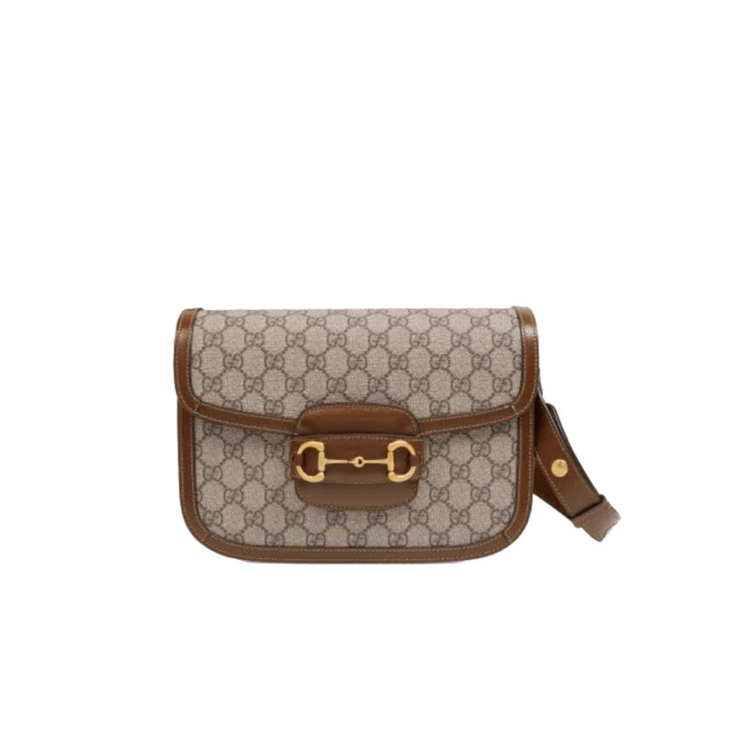 GUCCI 1955 Horsebit Shoulder Bag. High-end quality bag including gift box, literature, dust bag, authenticity card. Introduced for Cruise 2020, the Gucci 1955 Horsebit bag is recreated from an archival design. With the same lines and forms first introduced over six decades ago, the accessory unifies the original details with a modern spirit, highlighting the Horsebit. Part of Gucci’s genetic code, the double ring and bar design has been established as one of the most distinctive elements among the House symbols borrowed from the equestrian world. Presented on a small flap shoulder bag, the hardware is paired with the House’s monogram fabric and completed with a special mechanism that adjusts the length of the shoulder strap so it can be carried on one shoulder or cross body.