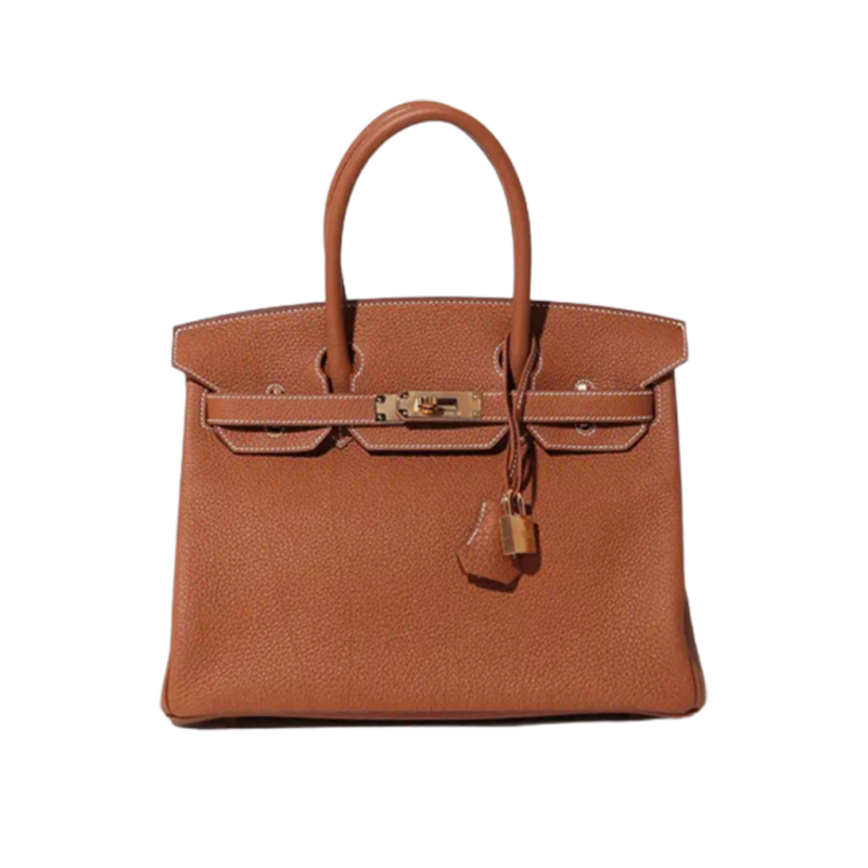 HERMÈS Birkin. Exquisite Craftsmanship and Timeless Elegance: Discover the Allure of the HERMES Birkin Bag Large Leather Top Handle. Designed with the actress Jane Birkin in mind, the Birkin bag is a contemporary development of the Kelly bag. Created based on Jane's suggestions, it was architected to be more significant to fit modern women's fast-paced life, with several minor yet outstanding adaptations, such as the elongated top handles. The French Birkin 30 bag is a classic touch of elegance to your look! The accessory features a trapeze body, a pebbled leather texture, a hanging key fob, gold-tone hardware, round top handles, a padlock fastening detail, a foldover top with twist-lock closure, a front center logo stamp, an internal zipped pocket, and purse feet.