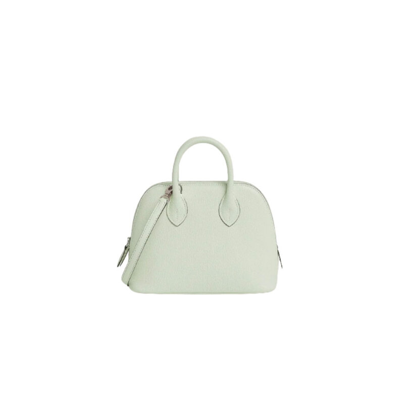 Bolide 1923 Mini. Timeless Elegance, Unparalleled Convenience: The Bolide Bag – A Journey in Every Stitch. Created in 1923 with the discerning needs of elite drivers and seasoned long-distance travelers in mind, this globe-trotting bag effortlessly finds its place within any automobile trunk. Its iconic round-angled shape owes its origins to the zip fastener, a novel invention introduced to France by Émile Hermès in the late 1910s, and this innovative feature enables swift access to its contents. The Bolide bag is available in various sizes, including a travel-sized version, and a range of handbag options, offering both style and functionality to its fortunate owners.