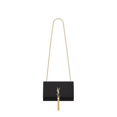 SAINT LAURENT Small 'Kate' Bag with Tassel. Original Quality Bag including gift box, care book, dust bag, authenticity card. Monogram Saint Laurent bag adorned with a curb chain, interlocking YSL initials in metal, and a metallic tassel. Crafted from leather, this Kate shoulder bag from Saint Laurent is decorated with a signature YSL monogram plaque and a hanging tassel detail to the front for an extra refined touch. The perfect go-to for a night out. Featuring a chain shoulder strap, a foldover top with magnetic closure, a main internal compartment, an internal slip pocket, an internal logo patch, an internal logo stamp, and metal hardware.