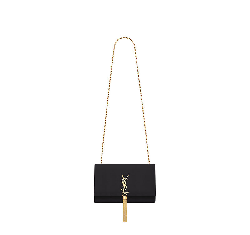 SAINT LAURENT Small 'Kate' Bag with Tassel. Original Quality Bag including gift box, care book, dust bag, authenticity card. Monogram Saint Laurent bag adorned with a curb chain, interlocking YSL initials in metal, and a metallic tassel. Crafted from leather, this Kate shoulder bag from Saint Laurent is decorated with a signature YSL monogram plaque and a hanging tassel detail to the front for an extra refined touch. The perfect go-to for a night out. Featuring a chain shoulder strap, a foldover top with magnetic closure, a main internal compartment, an internal slip pocket, an internal logo patch, an internal logo stamp, and metal hardware.