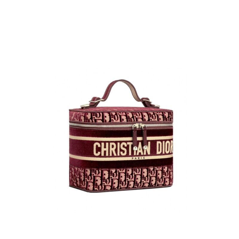 DIOR 'DiorTravel' Vanity Case. Original Quality Bag including gift box, care book, dust bag, authenticity card. The burgundy dior oblique embroidered velvet vanity case is crafted in the House's signature Cannage motif. The elegant design is fully embroidered, while the 'Christian Dior' signature accents the exterior. Pockets at the interior allow for a range of storage options, and a zip closure completes the piece.