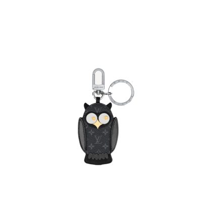 LOUIS VUITTON Owl Bag-Charm & Key Holder. Original Quality Charm including gift box, care book, dust bag, authenticity card. The mascot on the Owl bag charm and key holder is brought to life with LV studs for eyes and a Monogram Flower beak. Gold-color hardware joins calf leather and Monogram Eclipse canvas in a playful mingling of the House's signature materials. The hook and ring on this are both engraved with the Louis Vuitton signature for an elegant finish.