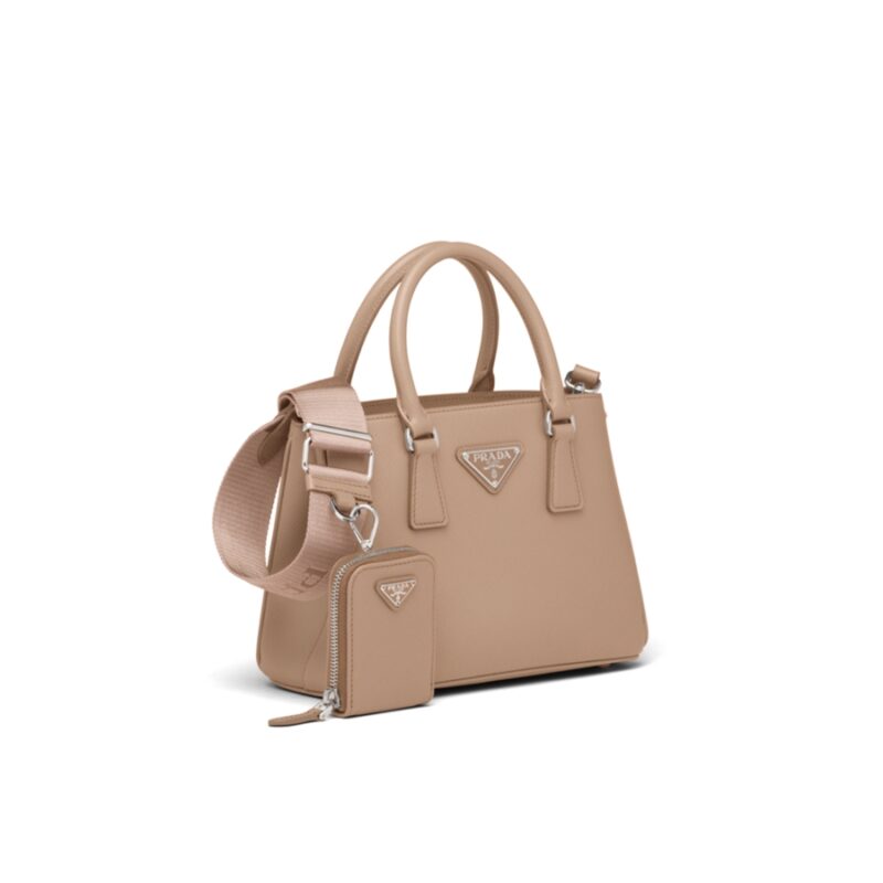 PRADA Galleria Micro Bag. Original Quality Bag including gift box, care book, dust bag, authenticity card. Prada has always been synonymous with transformation and experimentation with new fashion rules. The Prada Galleria bag, an expression of timeless elegance, is made of Prada's iconic Saffiano leather: leather defined by its crosshatch texture and waxed finish. With gimmicky hardware, usual shape and subtle style the bag is perfect for work, and also its truly practical with a shoulder strap. The bag owes its name to the historic Prada store that Mario Prada opened back in 1913 in Galleria Vittorio Emanuele II in Milan.
