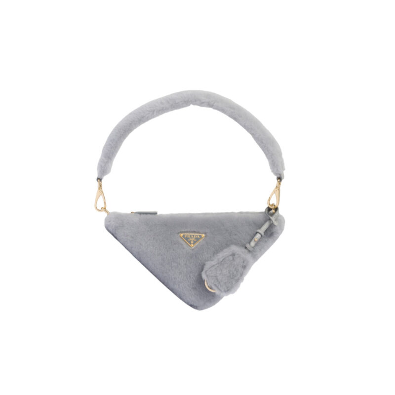 PRADA Shearling Mini Bag. Original Quality Bag including gift box, care book, dust bag, authenticity card. The softness and fuzziness of shearling accentuate the modern, wintry allure of this mini-bag characterized by its harmonious and delicate shape. The bag accented with a chain handle is decorated with the enameled metal triangle logo.