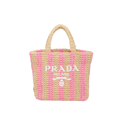 Small Crochet Tote Bag. Elevate Your Look with an Exquisite Tote Bag! This exquisite tote bag has a deconstructed design made of a light, natural material with a summery mood, raffia-effect yarn. Embroidered lettering logo decorates the front, and the emblematic triangle in enameled metal is the perfect finishing touch to the side.