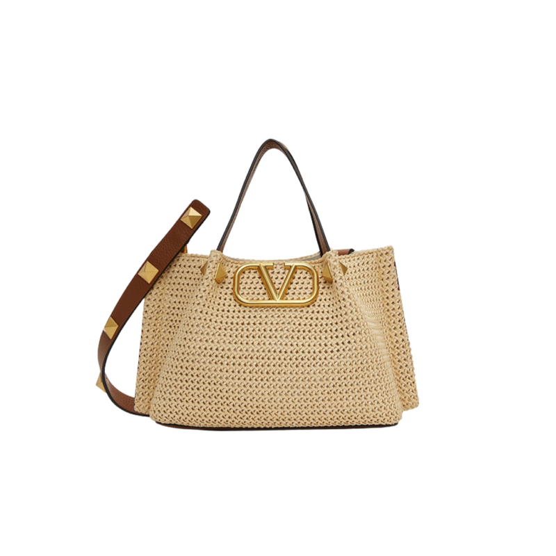 VALENTINO GARAVANI Straw Summer Small Tote. Original Quality Bag including gift box, literature, dust bag, authenticity card. The Summer tote bag is defined by its woven raffia design and the brass-toned VLogo plaque, the unmistakable symbol of Valentino Garavani. The detachable shoulder strap is adorned with the iconic Roman Studs, another of the brand's signature details.