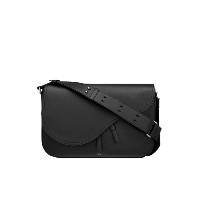 DIOR Saddle Messenger Bag. The Saddle messenger bag is a subtly elegant classic shape. Crafted in black grained calfskin, it is embellished with a flap featuring Saddle lines, and is further enhanced with a 'DIOR' signature. Its adjustable shoulder strap allows it to be worn over the shoulder or crossbody, while the spacious interior is completed with a patch pocket and can hold a 13-inch laptop, documents and a tablet.