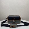 PRADA Nylon Cross-Body Bag. Original Quality Bag including gift box, care book, dust bag, authenticity card. This bag decorated with Saffiano leather trim presents compact volumes and a sleek design. With its distinctive side release buckle on the front, it comes with an easily adjustable shoulder strap. This cross-body bag featuring Saffiano leather trim with metal hardware and Prada logo lining, logo tag inside, enameled metal triangle logo outside. It has a main compartment with zipper, secondary compartment with flap and side release buckle, two front pockets, including one with zipper.
