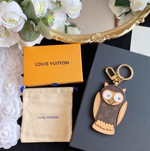 LOUIS VUITTON Owl Bag-Charm & Key Holder. Original Quality Charm including gift box, care book, dust bag, authenticity card. The mascot on the Owl bag charm and key holder is brought to life with LV studs for eyes and a Monogram Flower beak. Gold-color hardware joins calf leather and Monogram Eclipse canvas in a playful mingling of the House's signature materials. The hook and ring on this are both engraved with the Louis Vuitton signature for an elegant finish.