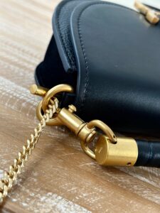 02Marcie Chain Flap Bag. Authentic quality luxury bag crafted in genuine leather comes with authenticity card, dust bag and gift bag. Elevating Iconic Elegance: Marcie Line Redefined. Experience a fresh take on *loé's iconic Marcie line with this exquisite chain flap bag, meticulously crafted from a captivating blend of nappa lambskin, grained calfskin, and sumptuous suede. The line's signature hardware undergoes a graceful transformation, now adorned with *loé's engraved jewelry hallmark, adorning the flap with sophistication. An intricately hand-braided top handle pays homage to another hallmark Marcie feature, while a gracefully extended chain strap adds a refined touch. Whether you choose to drape it over your shoulder or wear it cross-body during the day, or opt to detach the strap and carry it by hand for a sophisticated evening ensemble, this flap bag is a versatile masterpiece. *loé's Marcie bag line effortlessly melds a feminine aesthetic with the free-spirited vibe of the '70s. An equestrian-inspired allure takes center stage, elevated by the allure of gleaming gold-toned hardware, resulting in a distinctly feminine yet timelessly chic look. | PURSE POP UP LIVE Marcie Chain Flap Bag. Authentic quality luxury bag crafted in genuine leather comes with authenticity card, dust bag and gift bag. Elevating Iconic Elegance: Marcie Line Redefined. Experience a fresh take on *loé's iconic Marcie line with this exquisite chain flap bag, meticulously crafted from a captivating blend of nappa lambskin, grained calfskin, and sumptuous suede. The line's signature hardware undergoes a graceful transformation, now adorned with *loé's engraved jewelry hallmark, adorning the flap with sophistication. An intricately hand-braided top handle pays homage to another hallmark Marcie feature, while a gracefully extended chain strap adds a refined touch. Whether you choose to drape it over your shoulder or wear it cross-body during the day, or opt to detach the strap and carry it by hand for a sophisticated evening ensemble, this flap bag is a versatile masterpiece. *loé's Marcie bag line effortlessly melds a feminine aesthetic with the free-spirited vibe of the '70s. An equestrian-inspired allure takes center stage, elevated by the allure of gleaming gold-toned hardware, resulting in a distinctly feminine yet timelessly chic look.